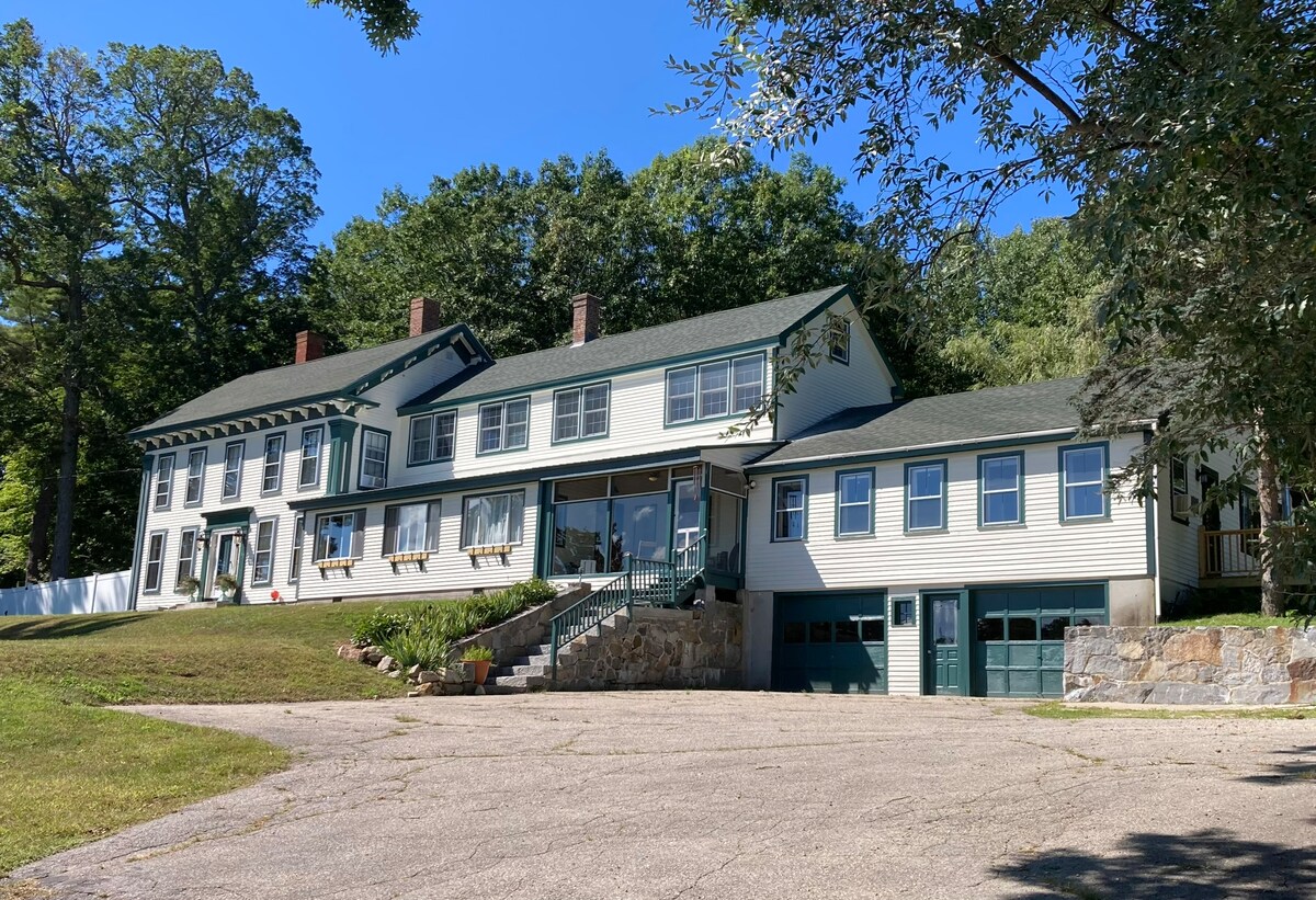 Two-story exterior of Wolfeboro Oaks with porch and driveway
