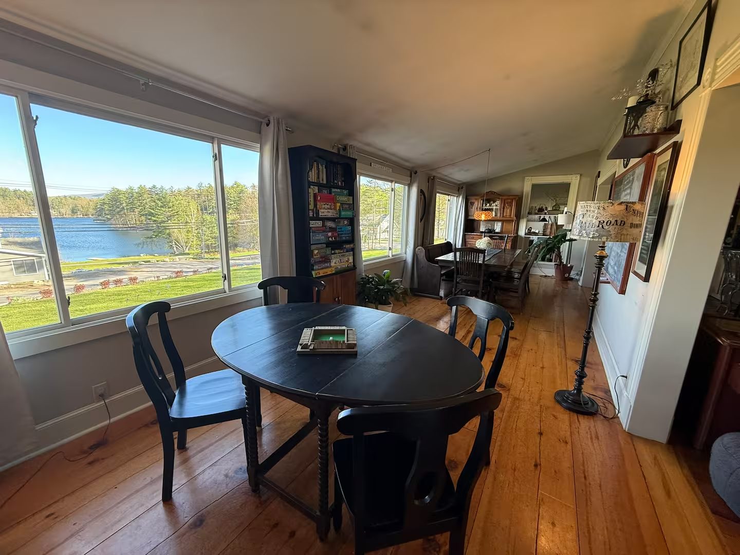 Games table by lake-view windows at Wolfeboro Oaks