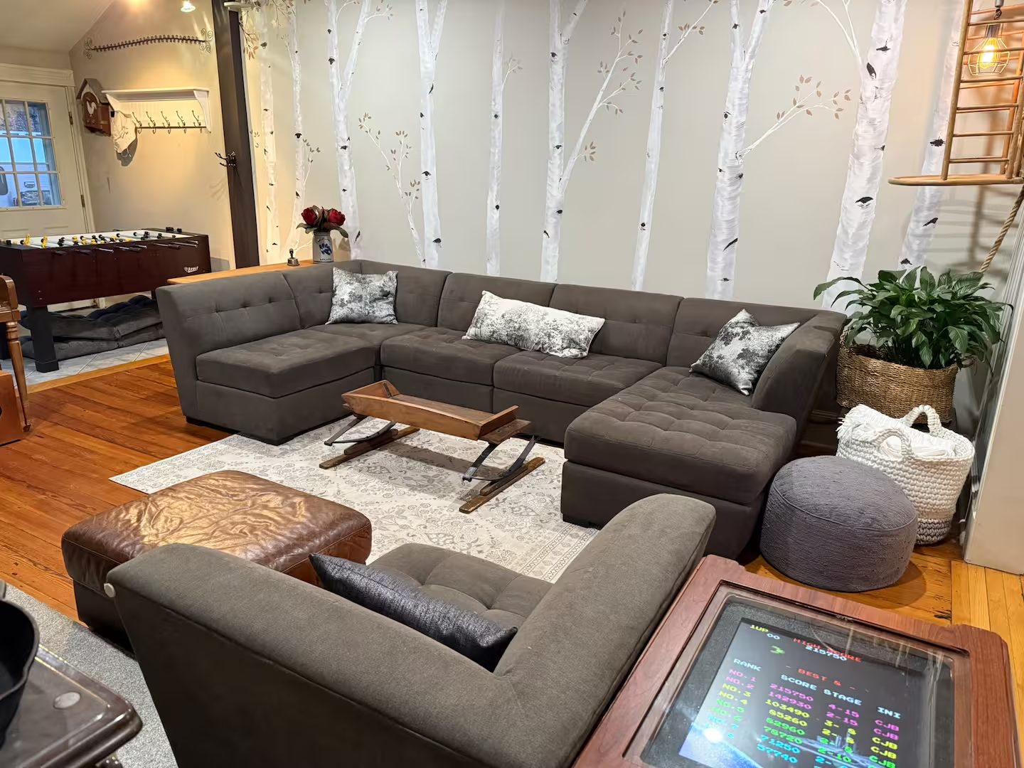 Living room with sectional, foosball, and arcade