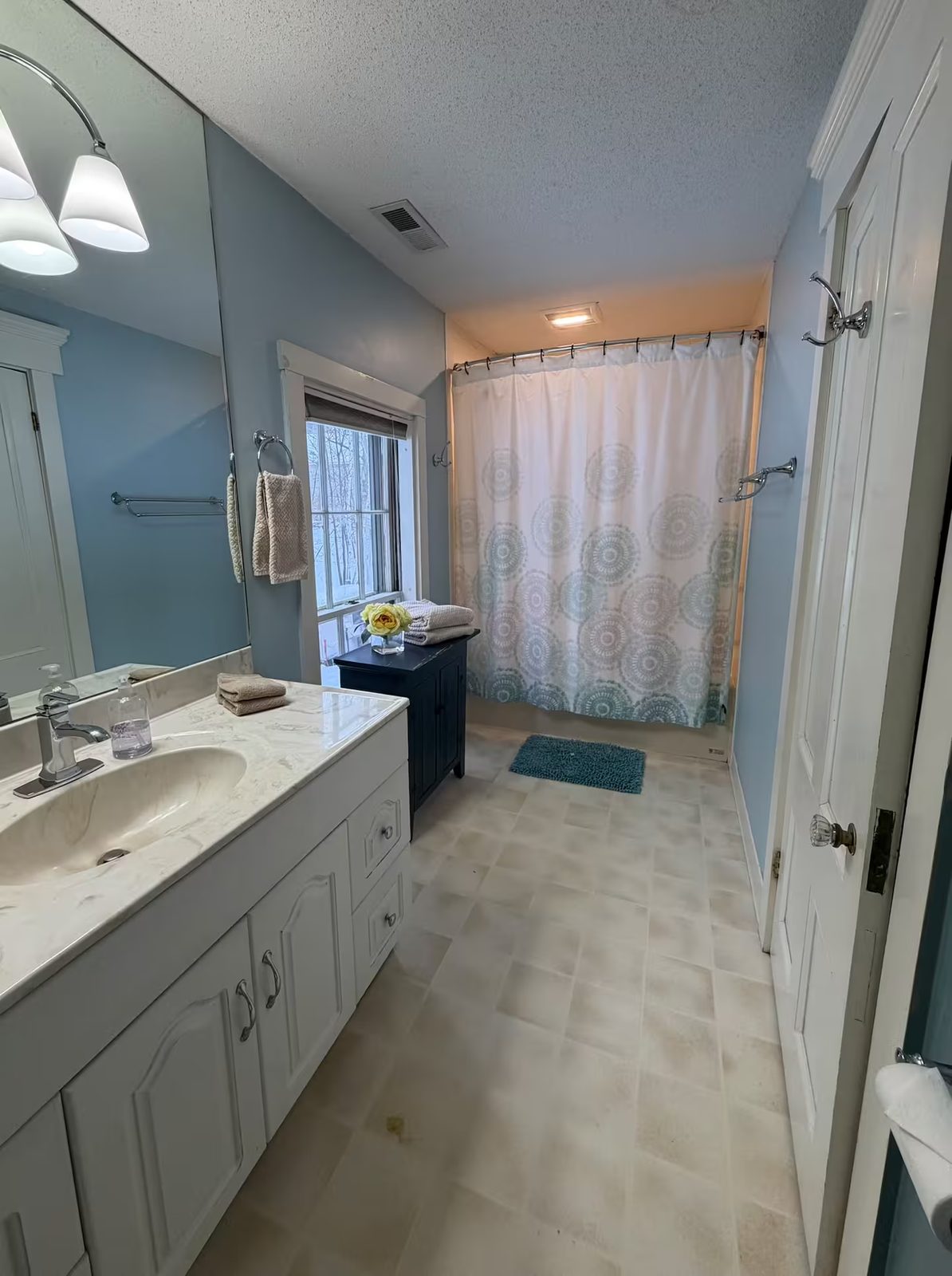Guest bathroom with vanity and tub shower