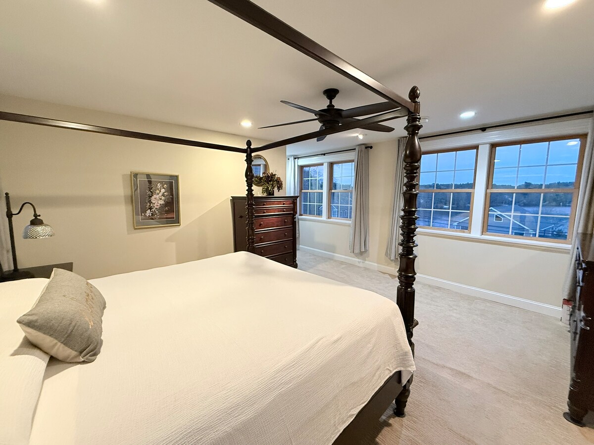 King master suite with multiple lake-facing windows
