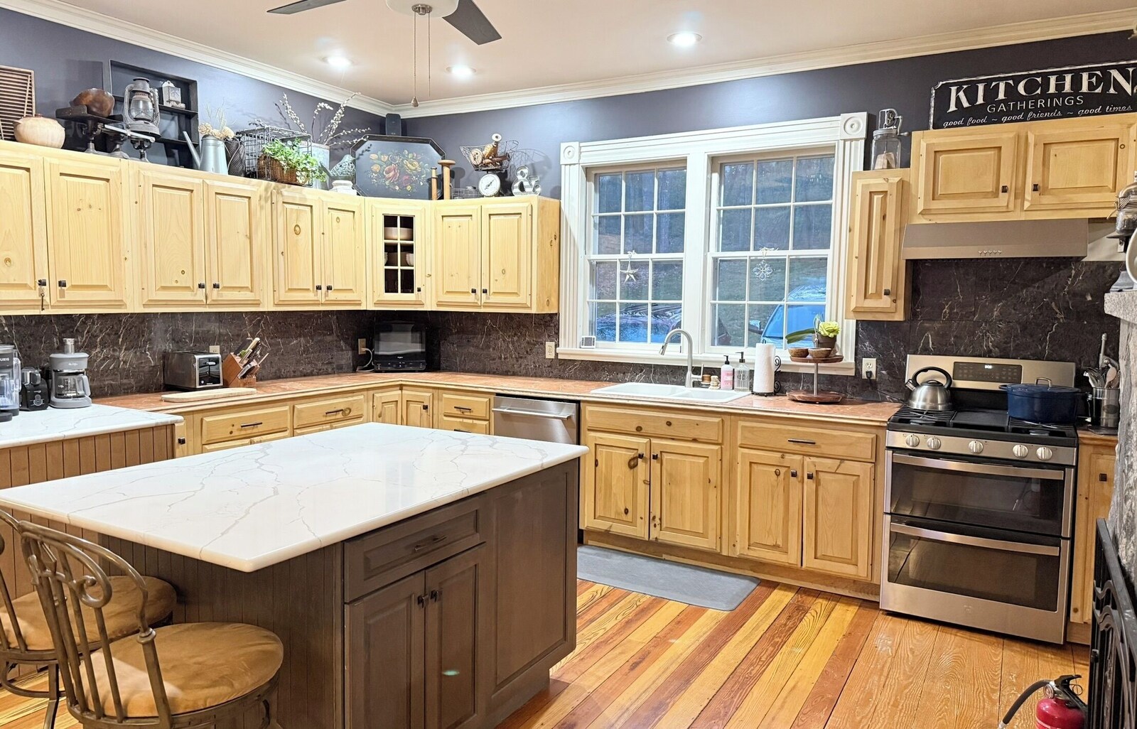 Kitchen with wood cabinets and marble counters